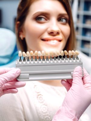 Young woman at the dentist's chair during a dental procedure. Overview of dental caries prevention.